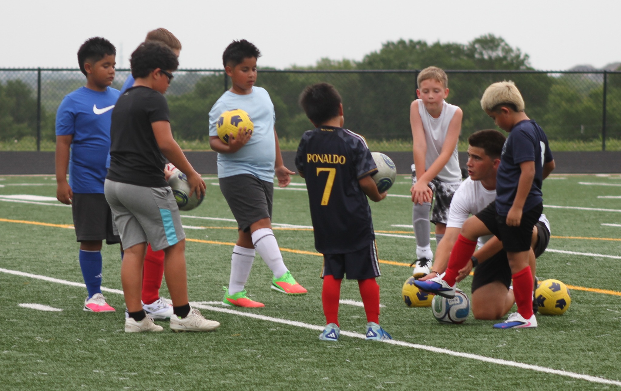 Coach Jose demonstrating the correct foot position to a young player